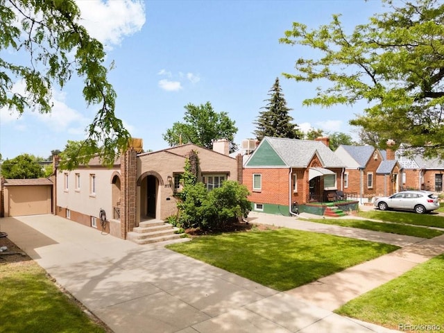 3739 W 46th Ave, Denver, CO 80211 - view of front facade featuring a front lawn, concrete driveway, brick siding, and a detached garage