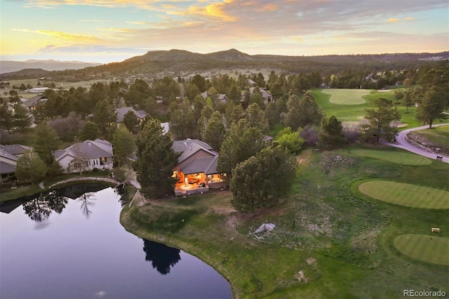 aerial view of property's location with a water and mountain view and a golf course
