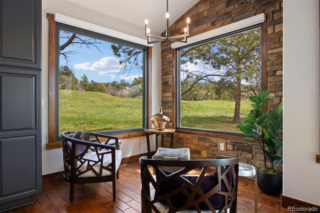 sunroom / solarium with lofted ceiling and a chandelier