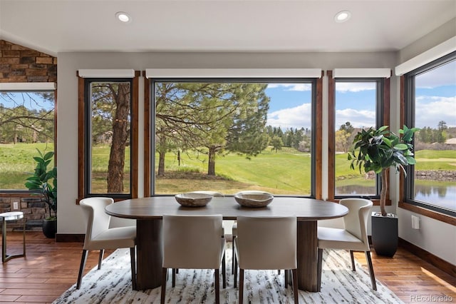 sunroom / solarium with wood-type flooring, baseboards, healthy amount of natural light, and recessed lighting