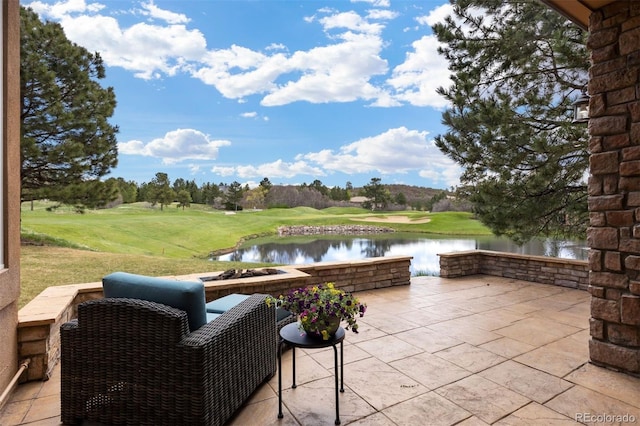 view of patio / terrace featuring a water view and view of golf course