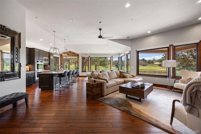 living room with recessed lighting, ceiling fan, and dark wood-type flooring