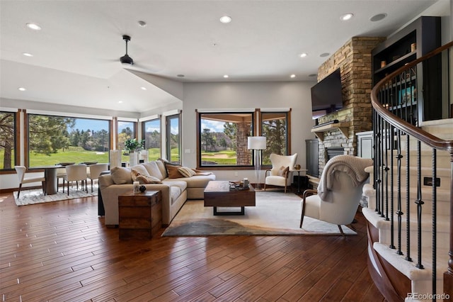 living room featuring plenty of natural light, recessed lighting, a fireplace, a ceiling fan, and hardwood / wood-style flooring
