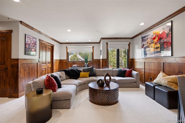 carpeted living room featuring a wainscoted wall, wood walls, recessed lighting, and ornamental molding