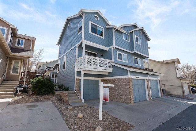 view of front of house featuring a balcony, driveway, and a garage