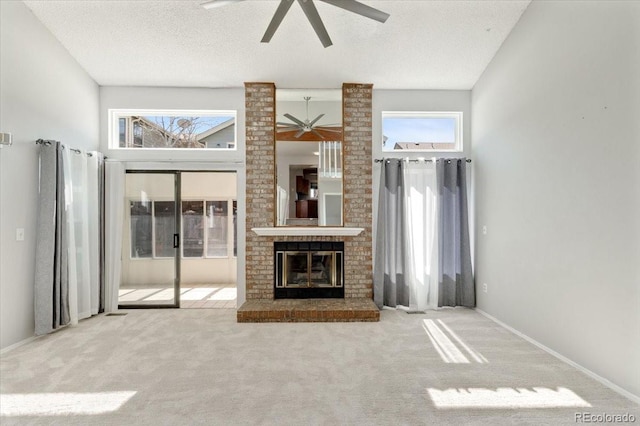 unfurnished living room with a wealth of natural light, carpet floors, and ceiling fan