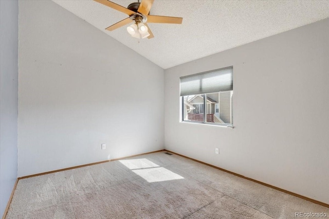 carpeted spare room featuring visible vents, lofted ceiling, a ceiling fan, a textured ceiling, and baseboards