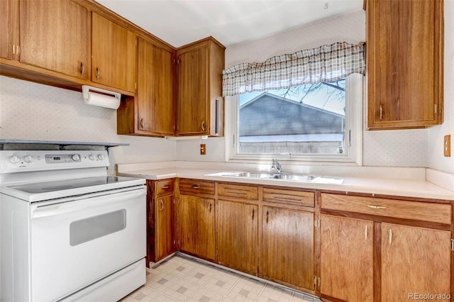 kitchen with white range with electric cooktop and sink