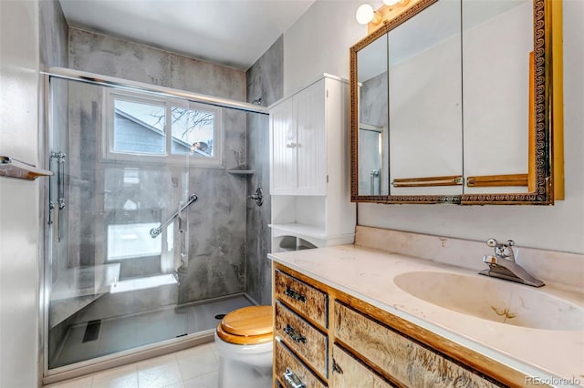 bathroom featuring vanity, a shower with shower door, and toilet