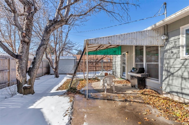 view of patio / terrace with area for grilling and a shed