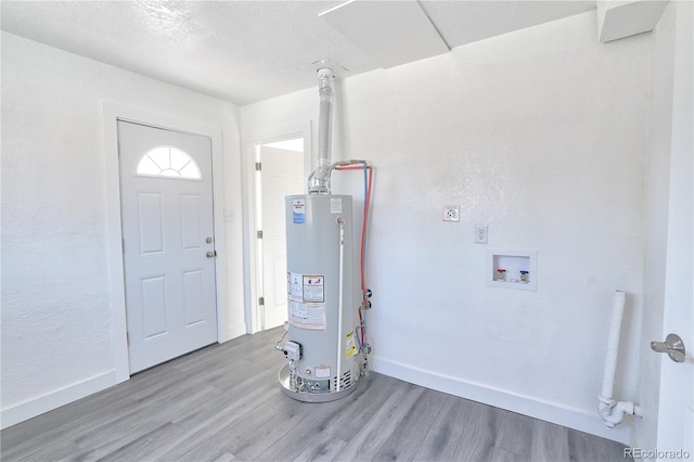 foyer entrance with wood-type flooring and gas water heater