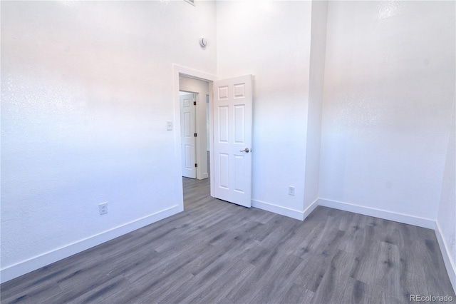 empty room with dark wood-type flooring