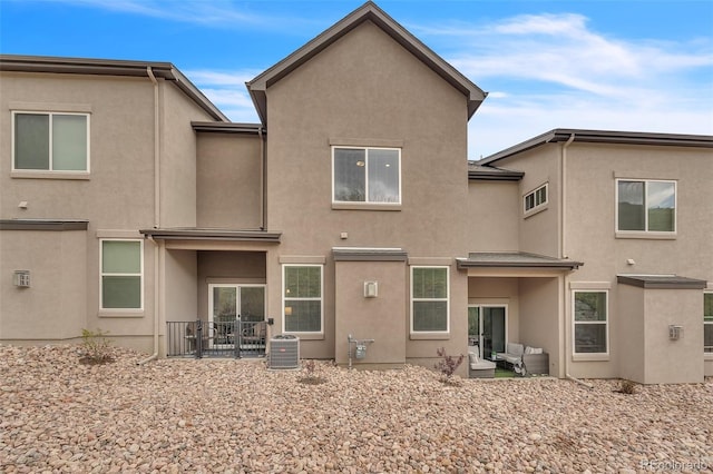 5714 Villa Lorenzo Dr, Colorado Springs, CO 80919 - rear view of house featuring stucco siding, central air condition unit, and an outdoor living space