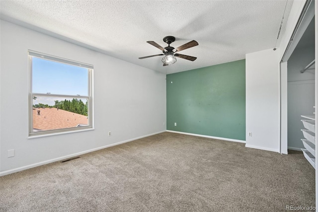 920 44th Avenue Ct Unit 30, Greeley, CO 80634 - unfurnished bedroom featuring carpet, a textured ceiling, and a ceiling fan