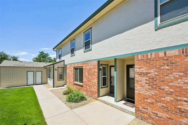920 44th Avenue Ct Unit 30, Greeley, CO 80634 - rear view of property featuring stucco siding and brick siding