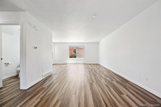 920 44th Avenue Ct Unit 30, Greeley, CO 80634 - unfurnished living room featuring wood finished floors and a textured ceiling