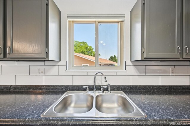 920 44th Avenue Ct Unit 30, Greeley, CO 80634 - kitchen with gray cabinets, tasteful backsplash, and dark stone countertops