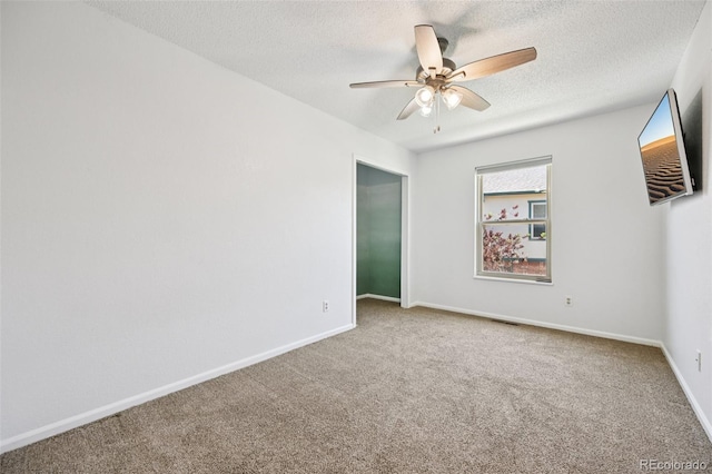 920 44th Avenue Ct Unit 30, Greeley, CO 80634 - carpeted empty room featuring a ceiling fan and a textured ceiling