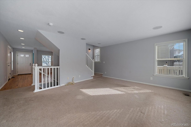 carpeted spare room with a wealth of natural light