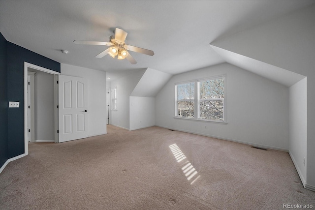 bonus room with ceiling fan, light colored carpet, and lofted ceiling