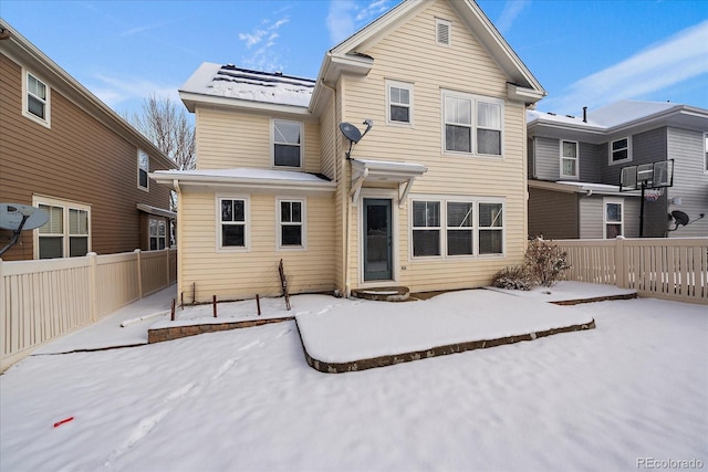 view of snow covered rear of property