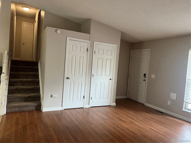 unfurnished bedroom with hardwood / wood-style floors and a textured ceiling