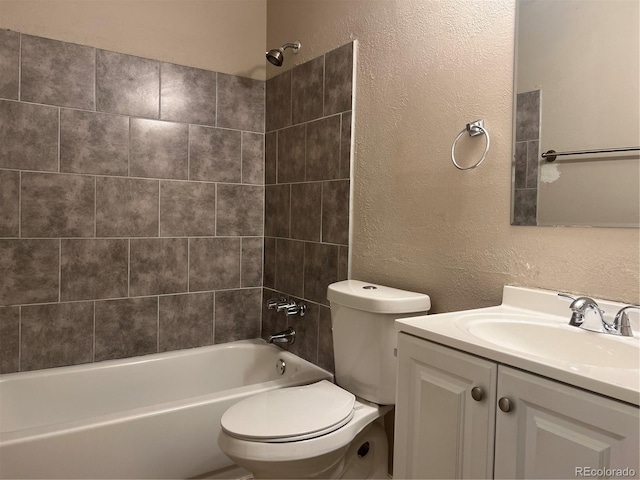 full bathroom with toilet, vanity, and tiled shower / bath