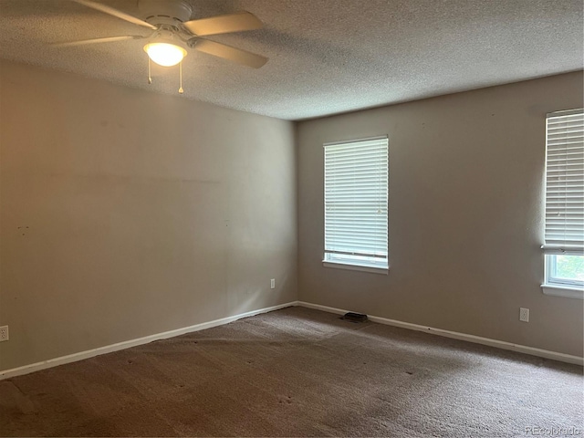 spare room with ceiling fan, a textured ceiling, and carpet floors