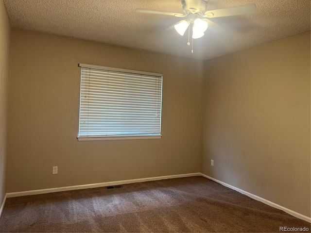 carpeted empty room featuring a textured ceiling and ceiling fan