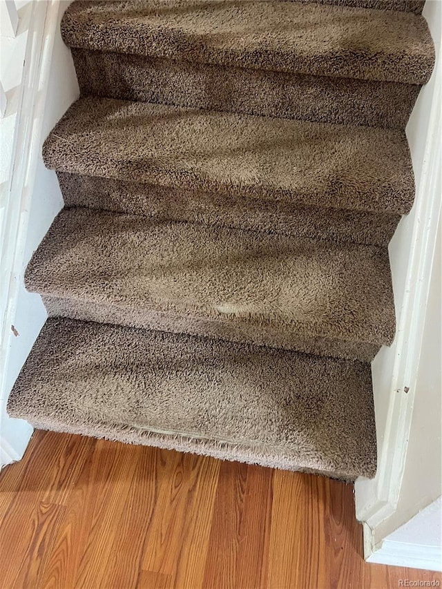 stairs with hardwood / wood-style flooring