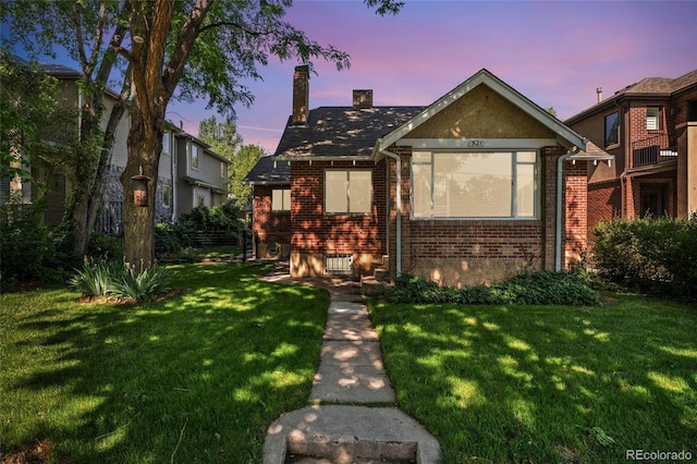521 Harrison St, Denver, CO 80206 - view of front of house with brick siding, a chimney, and a front lawn