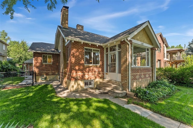 521 Harrison St, Denver, CO 80206 - back of house featuring entry steps, brick siding, and a chimney