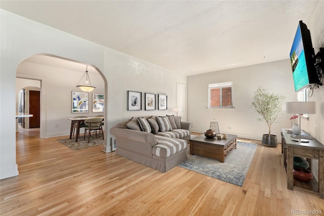 521 Harrison St, Denver, CO 80206 - living area with arched walkways and light wood-style flooring