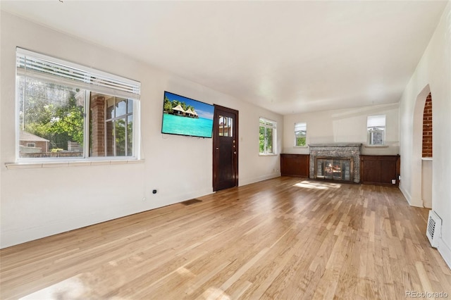 521 Harrison St, Denver, CO 80206 - unfurnished living room featuring light wood-style floors and a glass covered fireplace