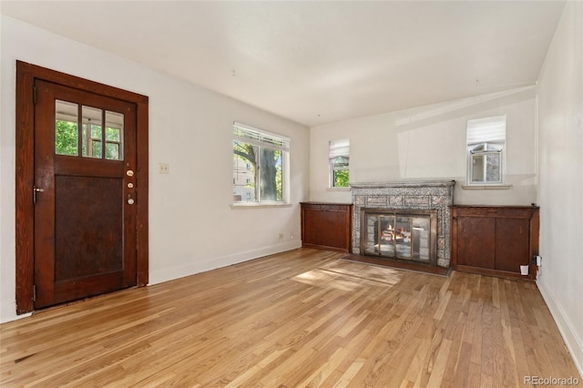 521 Harrison St, Denver, CO 80206 - unfurnished living room with light wood-style floors and a stone fireplace