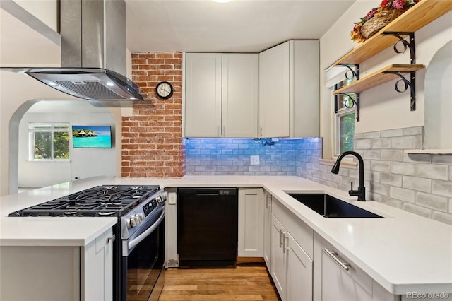 521 Harrison St, Denver, CO 80206 - kitchen featuring black dishwasher, island exhaust hood, stainless steel range with gas cooktop, open shelves, and backsplash