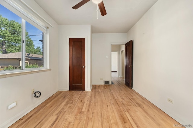 521 Harrison St, Denver, CO 80206 - unfurnished bedroom with light wood-type flooring, multiple windows, and a ceiling fan