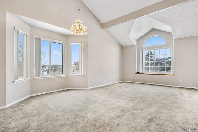 unfurnished living room with lofted ceiling, plenty of natural light, and carpet