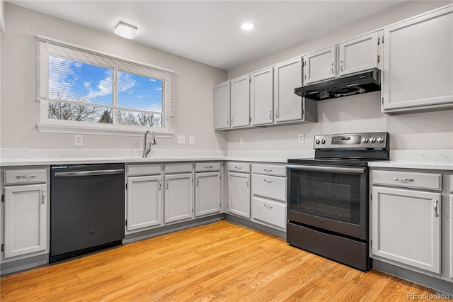 kitchen featuring sink, stainless steel electric stove, dishwasher, and light hardwood / wood-style floors