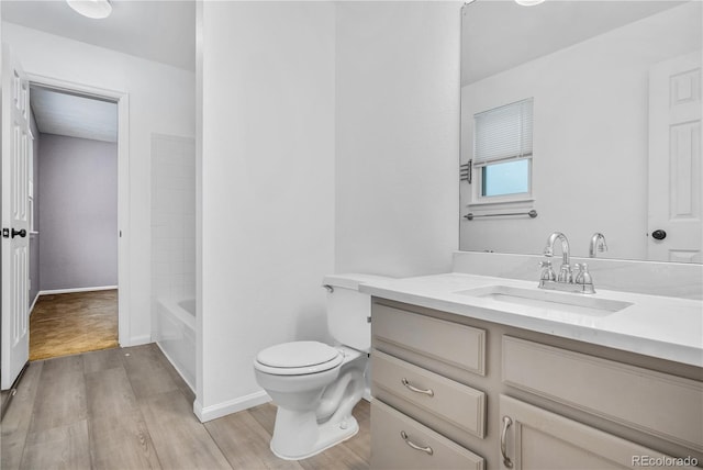 full bathroom featuring vanity, tub / shower combination, hardwood / wood-style floors, and toilet