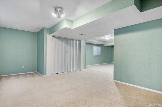 basement featuring light colored carpet