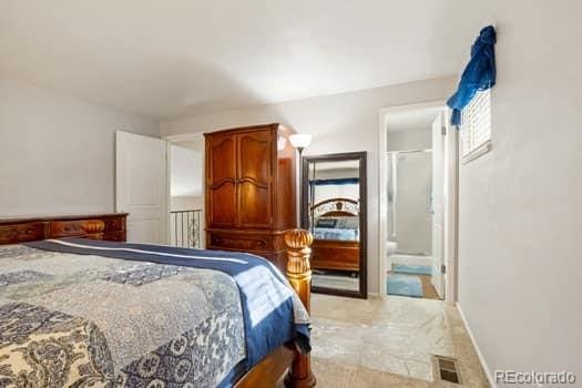 bedroom featuring visible vents and baseboards