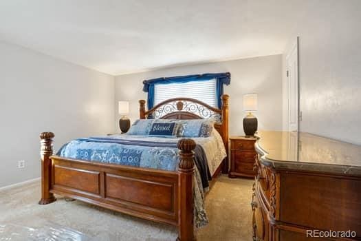 bedroom featuring light colored carpet