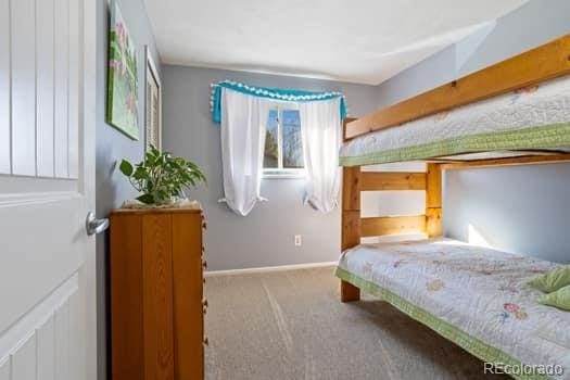 bedroom featuring carpet floors and baseboards