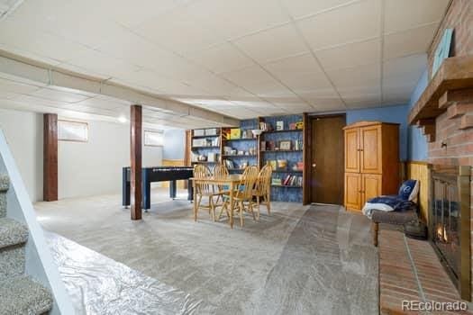 dining area featuring a fireplace and a paneled ceiling