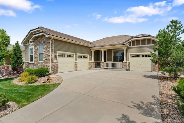 10182 Bristleridge St, Parker, CO 80134 - craftsman inspired home featuring an attached garage, a porch, concrete driveway, stone siding, and a tiled roof