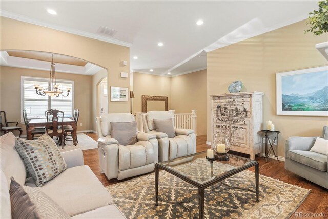 10182 Bristleridge St, Parker, CO 80134 - living area featuring arched walkways, wood finished floors, baseboards, recessed lighting, and a chandelier