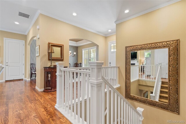 10182 Bristleridge St, Parker, CO 80134 - hall featuring an upstairs landing, wood finished floors, healthy amount of natural light, arched walkways, and crown molding