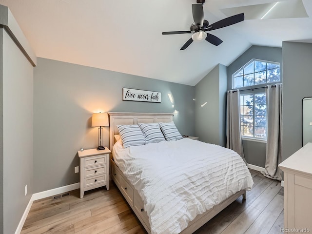 bedroom with light hardwood / wood-style flooring, ceiling fan, and lofted ceiling