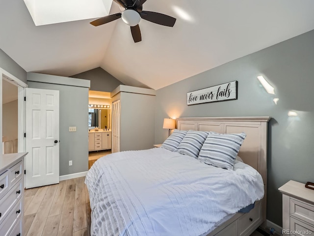 bedroom featuring ensuite bathroom, ceiling fan, light hardwood / wood-style floors, a closet, and lofted ceiling